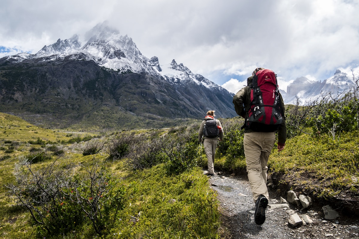 A hiker ascending a steep mountain trail representing the willingness to embrace difficult challenges
